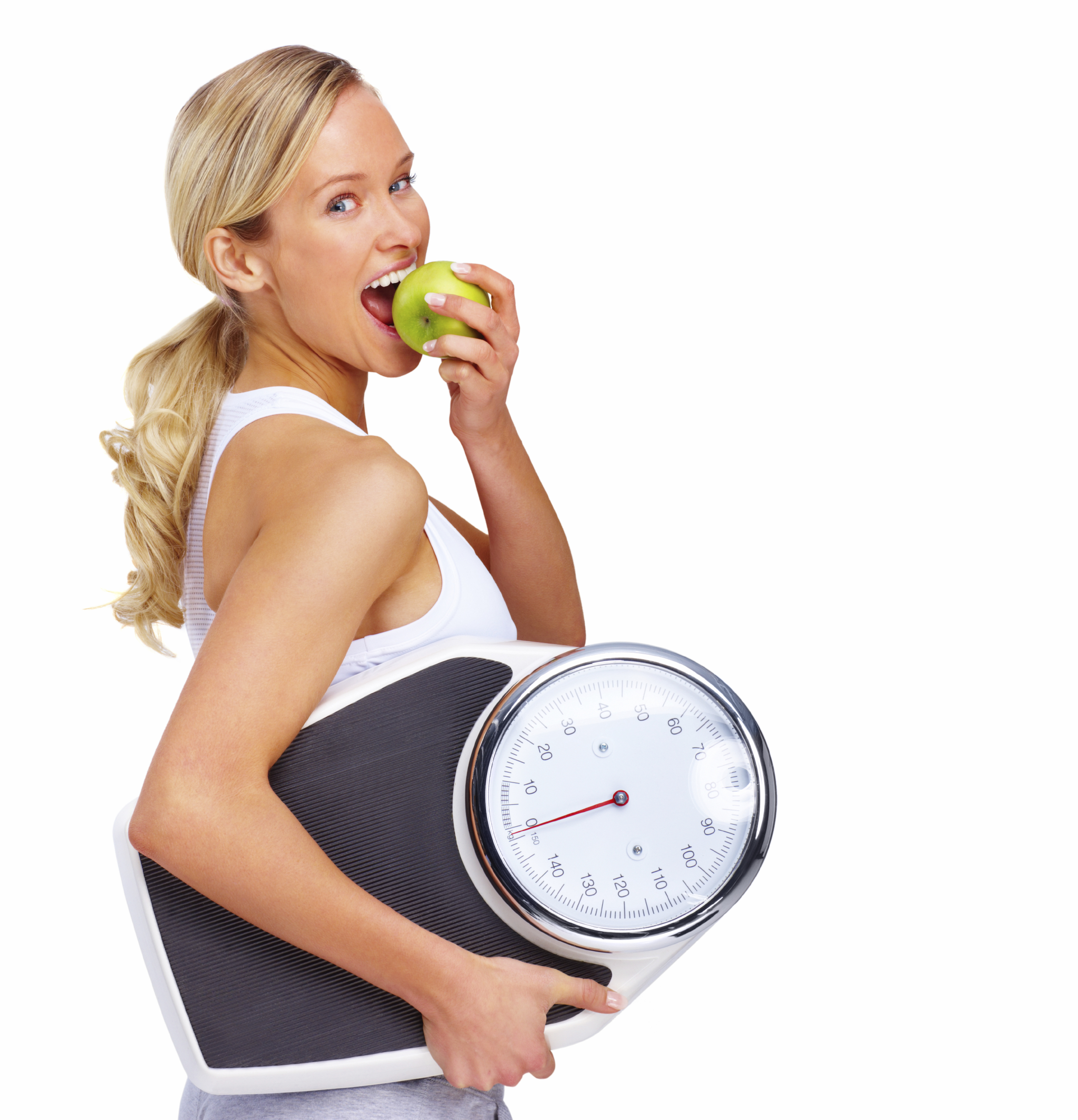 Young woman eating apple and carrying a weight scale over white background