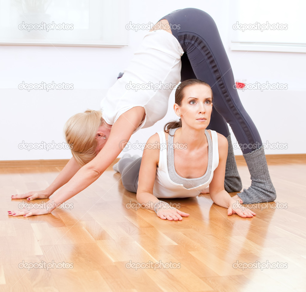 Group of sport women in the gym centre doing stretching fitness exercise. Yoga